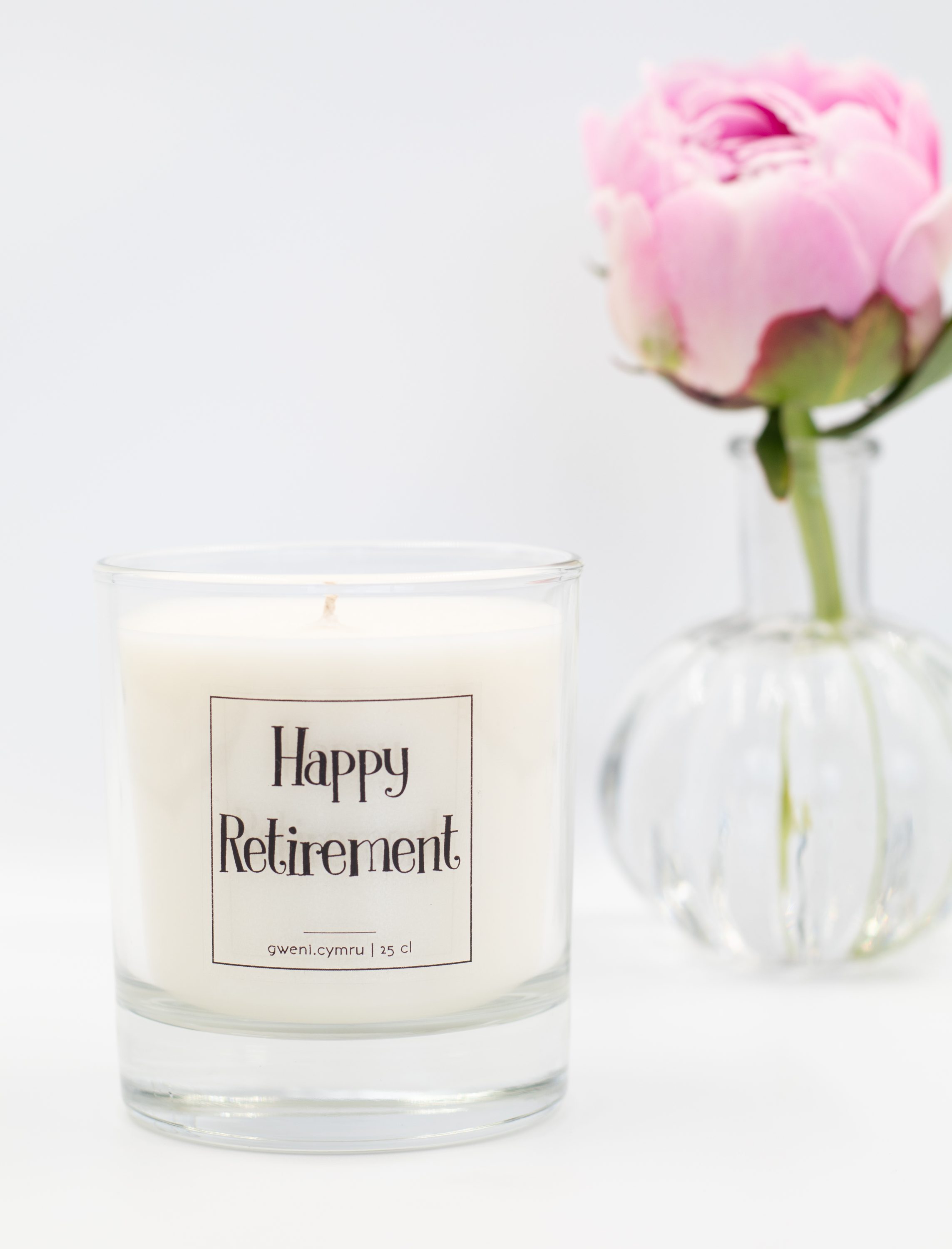An image of the soy candle with 'Happy Retirement' label